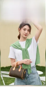 Classic plaid cylinder bag styled with white T-shirt and denim skirt for outdoor look