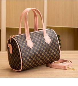 Detail of Boston barrel bag featuring brown monogram pattern and soft pink leather trim