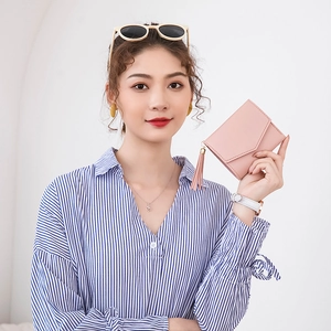Pink short tassel wallet for women with elegant envelope flap design in lifestyle setting