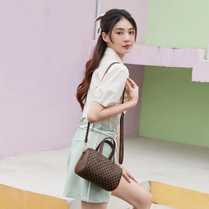 Classic checkered Boston barrel bag with brown monogram pattern and golden hardware