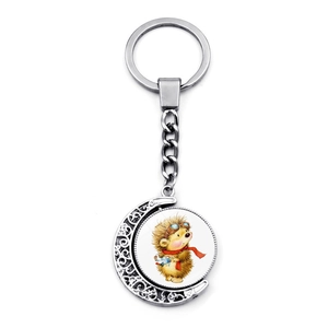 Rotating crescent moon keychain featuring a cartoon hedgehog playing the violin in silver finish