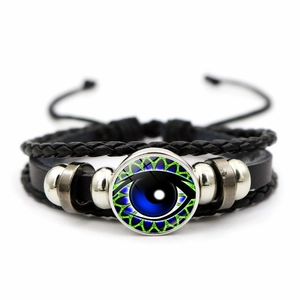 Detail of multi-layer braided leather bracelet featuring realistic blue evil eye glass bead