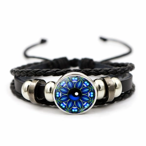 Close-up of Eye of Horus braided leather bracelet with blue mandala glass cabochon