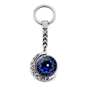 Rotating Eye of Horus moon keychain with blue evil eye pendant on a silver metal ring