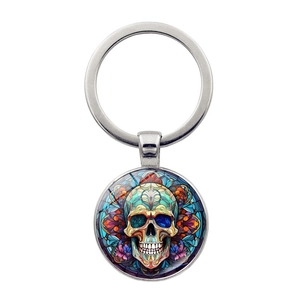 Detail of keychain featuring colorful skull design in stained glass style with glass dome