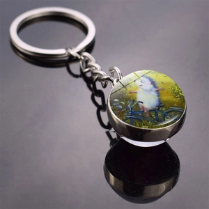 Double-sided glass ball keychain featuring a cute hedgehog riding a bike illustration