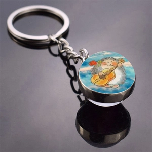 Detailed view of hedgehog guitar illustration inside a round glass dome keychain