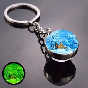 Luminous Christmas keychain with winter snow scene cabin pattern glowing in the dark