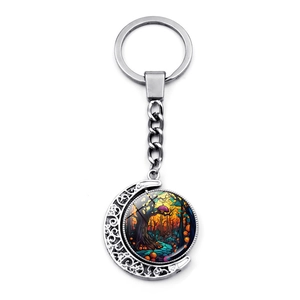 Detail of Halloween ghost castle moon keychain with colorful forest stained glass insert