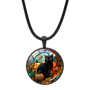 Detail of stained glass style Halloween necklace pendant with black cat and pumpkin scene