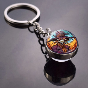 Detail of Halloween keychain with double-sided glass dome showing a spooky scarecrow