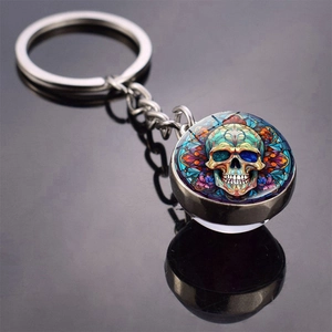 Macro shot of Halloween skull glass dome keychain with colorful mandala patterns