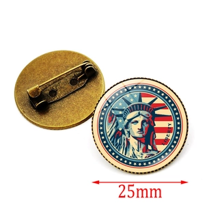 Detail view of 25mm round Liberty pin badge with Statue of Liberty and US flag design