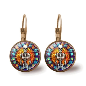 Macro detail of skeleton mandala glass cabochon earrings with bronze lever-back
