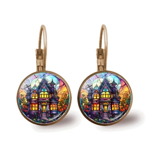 Macro shot of Halloween lever-back earrings featuring a glowing haunted house and moon art