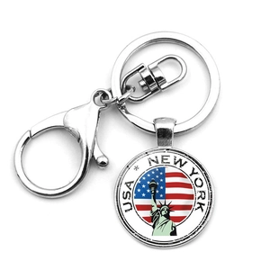 Detail of metal keychain with Statue of Liberty and USA flag charm on white background