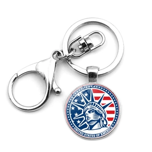 Detailed view of silver souvenir keychain featuring Statue of Liberty and USA flag