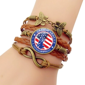 Detail of multi-layer leather bracelet with US flag, Statue of Liberty and infinity charm