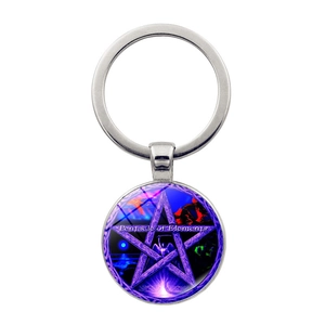 Macro detail of mystical pentagram glass pendant keychain with Pentacle of Elements design