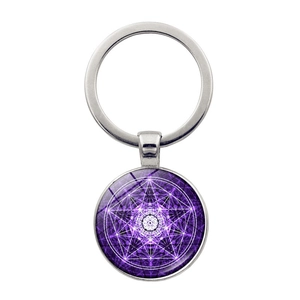 Macro view of purple mandala glass pendant keychain with silver geometric star pattern