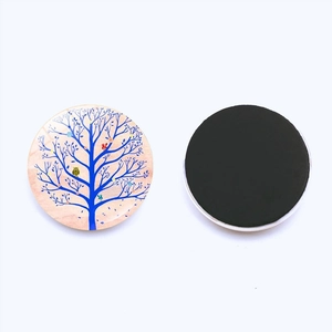 Detailed view of Tree of Life glass fridge magnet with creative blue tree and magnetic back