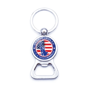 Detail of silver metal bottle opener keychain with Statue of Liberty and USA flag badge