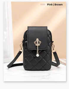 Detail of black quilted leather mini bag featuring gold crown ornament and pearl charm