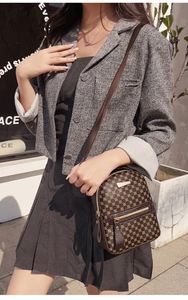 Detail view of a vintage mini crossbody bag with geometric pattern and gold metal accents