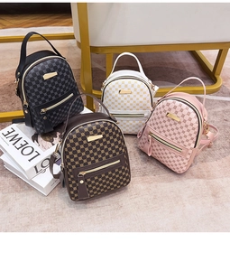 Detailed view of four mini backpacks in black, brown, white and pink with circular patterns