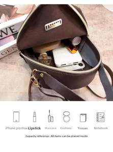 Detail view of small round crossbody bag showing interior capacity for iPhone and cosmetics