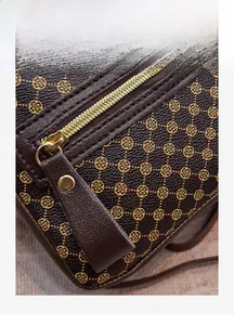 Detail of smooth golden zipper and extended leather puller on printed backpack