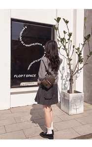Brown checkered crossbody backpack shown in a real-world outdoor lifestyle setting