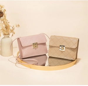 Detail of quilted leather crossbody bags with gold square lock and elegant styling