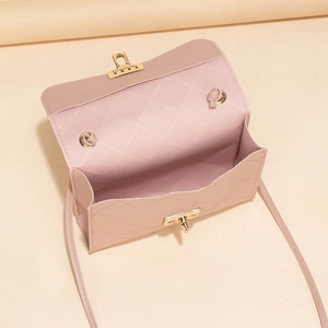 Pink quilted crossbody bag with gold twist lock and interior storage compartment