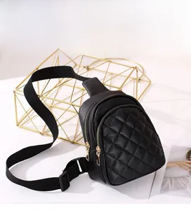 Detail of black quilted leather chest bag featuring gold zipper and adjustable strap
