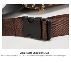 Detail of adjustable black plastic buckle and brown woven strap for crossbody bag