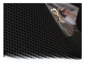 Detailed back view showing black breathable honeycomb mesh material with gold hook