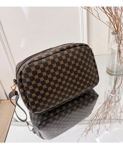Detail of coffee brown PU leather crossbody bag with vintage golden floral print