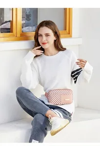 Pink monogram waist bag with adjustable strap and golden logo plate on pink front pocket