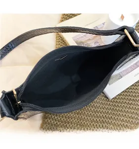 Top macro view of black crocodile pattern shoulder bag interior with high capacity