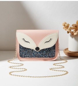 Détail du sac renard rose avec finition pailletée et bandoulière en chaîne dorée