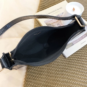 Women black crocodile pattern shoulder bag with gold hardware shown from top view