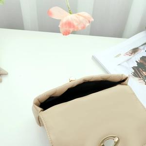 Quilted crossbody shell bag in beige with gold metal lock and interior view