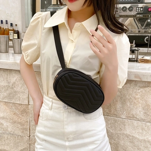 Quilted black oval crossbody chest bag with adjustable strap in casual minimalist style