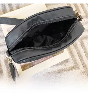 Top view of spacious interior compartment with dark fabric lining and gold hardware