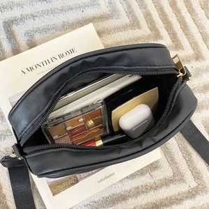 Black PU leather crossbody bag with adjustable strap and organized interior storage