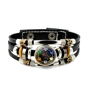 Macro detail of leather bracelet featuring occult pentagram glass cabochon and metal beads