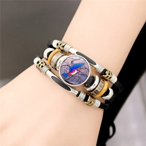 Braided leather bracelet with colorful hummingbird charm and vintage metallic beads
