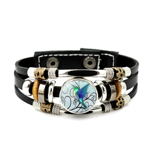 Macro detail of men's leather hummingbird bracelet with colorful glass dome and metal beads