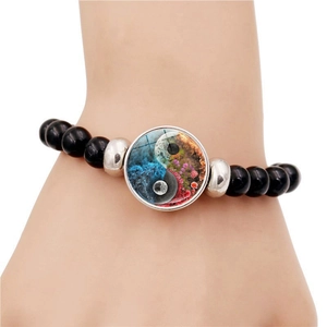 Black beaded elastic bracelet featuring creative Yin Yang pendant and silver spacers